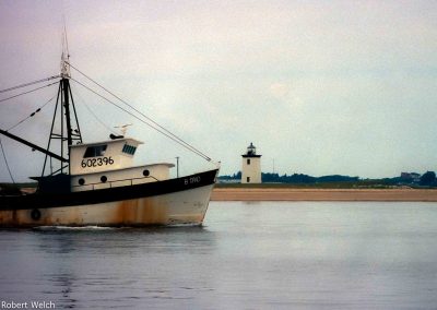fishing boat sailing into Provincetown harbor - film shot from 1988