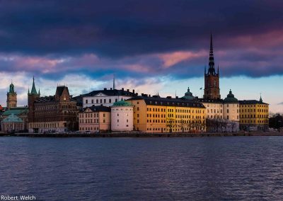 a view across the water of Stockholm Old Town as the sun goes down