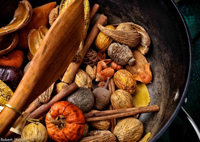 colorful still life off nuts and gourds in an iron pan