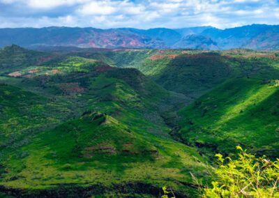 green ridges of Waimea Canyon with distant mountains