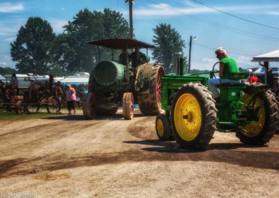 Aultman Taylor steam tractor and vintage John Deere meet at a crossroad