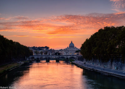 Roman sunset over the Tiber River with St Peter's in the background